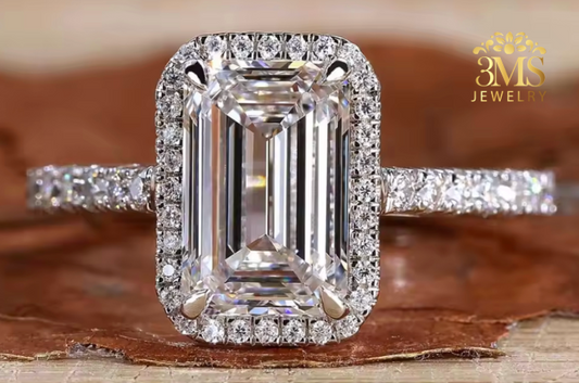 "Lab diamond emerald-cut engagement ring in halo design and 14K yellow gold settings—a close-up view."