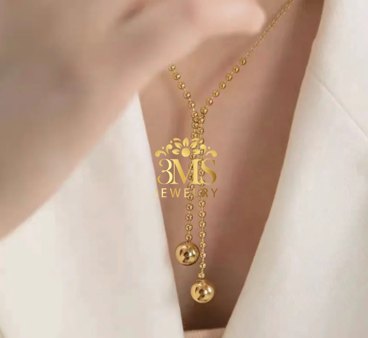 "18K gold two-beaded pendant necklace in titanium steel with gold vermeil—neck-wearing view"