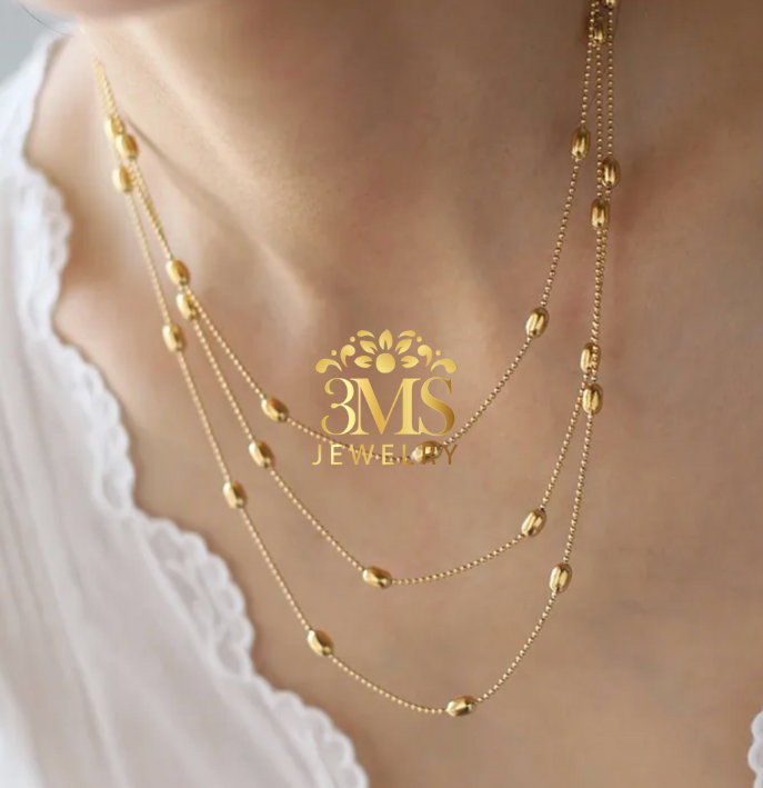 "18K gold three-layered beads necklace in titanium steel with gold vermeil—wearing full front details"