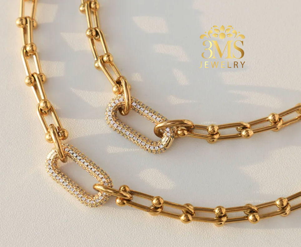 "18K gold link set necklace and bracelet in titanium steel with gold vermeil—front full view"