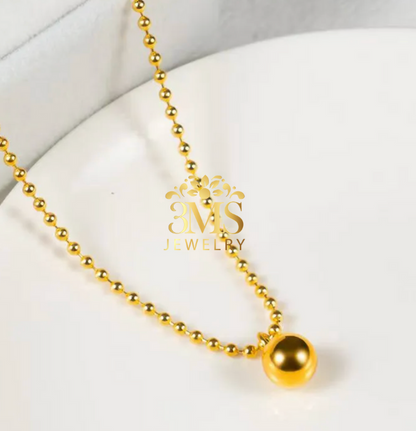 "18K gold beaded pendant necklace in titanium with gold vermeil—full-length side view"