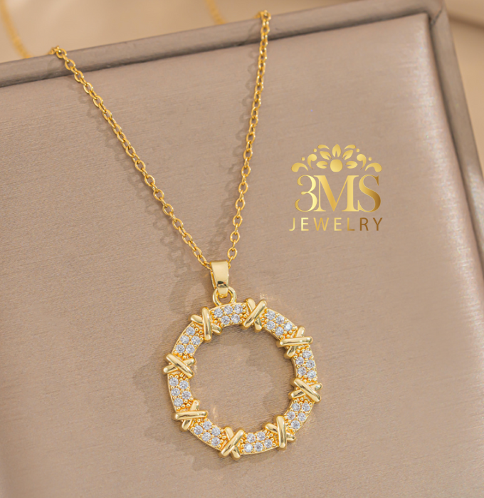 "18K gold x design with white zircon stone in titanium steel with gold vermeil - front view"
