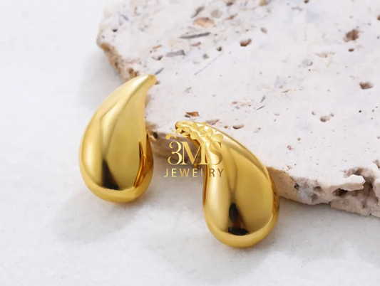 "18K gold droplet earrings in titanium steel with gold vermeil—front view"