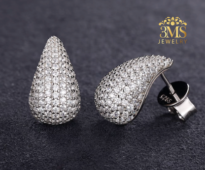 "1.67 ct. moissanite teardrop earrings in sterling silver with white gold vermeil—front, side, and back view"