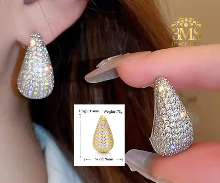 Teardrop-shaped diamond earrings being worn, with a close-up inset showing earring dimensions.