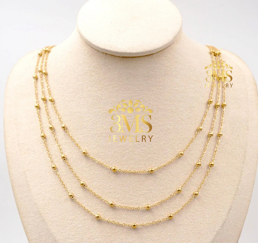 "18K gold three-layer beads necklace in titanium steel with gold vermeil—front-zoom view"