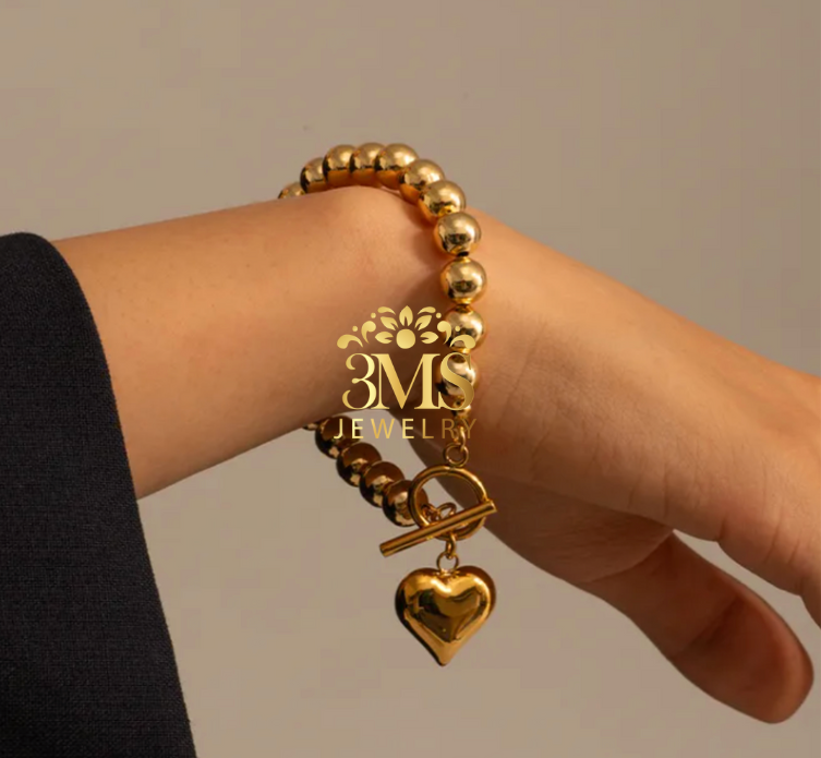 "18K gold beads heart pendant bracelet in titanium steel with gold vermeil - on wrist wearing view"