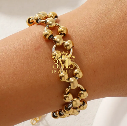 "18K gold lock beads in titanium steel with gold vermeil—on wrist detail"