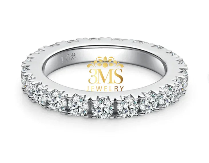 14K white gold eternity band with round moissanite stones in prong settings