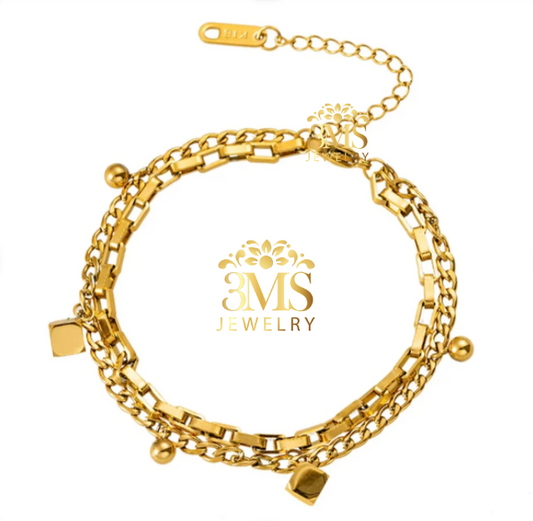 "18K gold chain bracelet with charms in titanium steel with gold vermeil - front view"