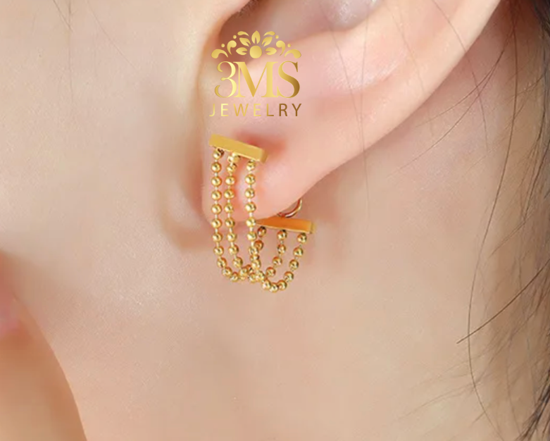 "18K gold beaded lock earrings in titanium steel with gold vermeil—on ear-wearing view"