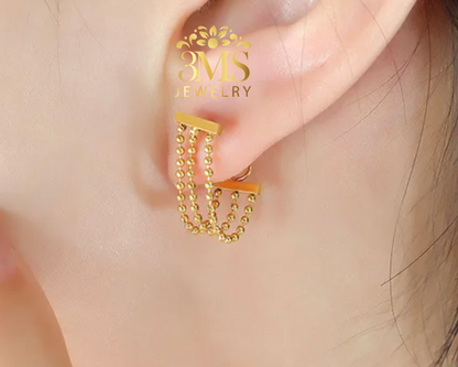 "18K gold beaded lock earrings in titanium steel with gold vermeil—on ear-wearing view"
