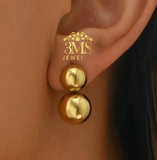 "18K gold two-beaded drop earrings in titanium steel with gold vermeil—on-ear wearing view"