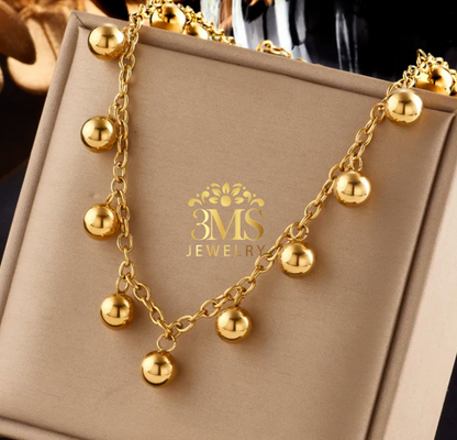 "18K gold beaded choker necklace in a titanium steel with gold vermeil—full view"