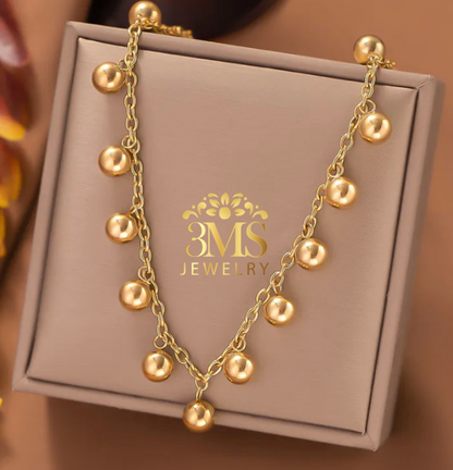 "18K gold beaded choker necklace in a titanium steel with gold vermeil—full detail"