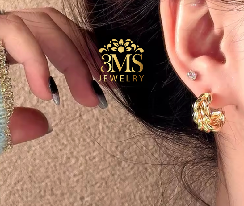 "18K gold hoop earring breaded design in titanium steel with gold vermeil—wearing front view"