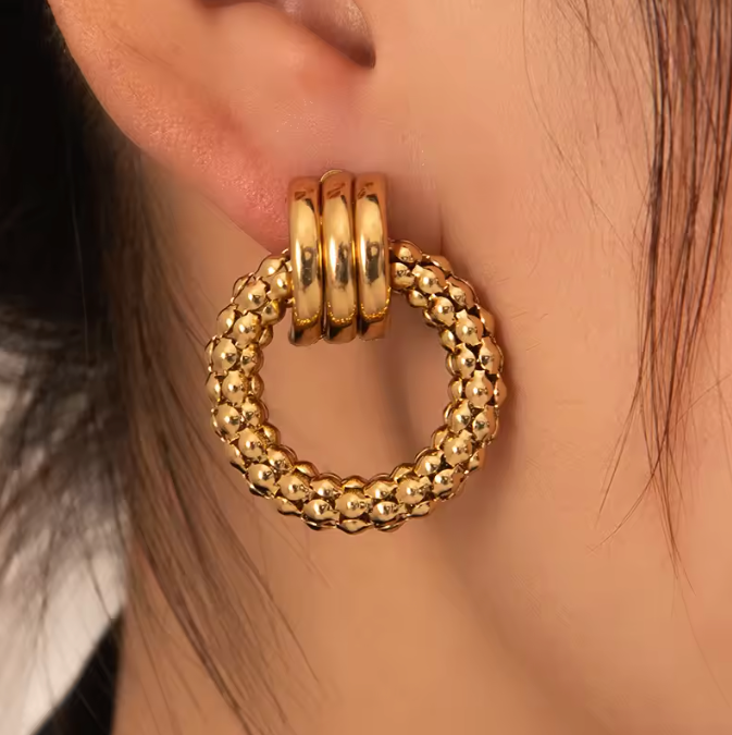 "18K gold hoop earrings in titanium steel with gold vermeil—ear-wearing view"