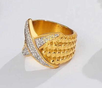 Gold ring with textured braided design and diamond accents on white background