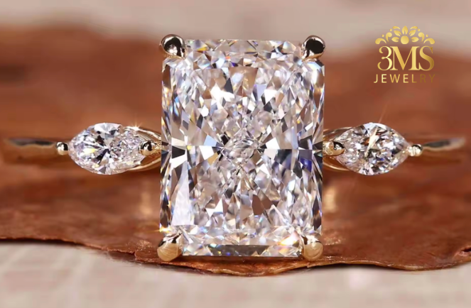"Lab diamond radiant-cut engagement ring in three-stone design and 14K yellow gold settings—a close-up view."