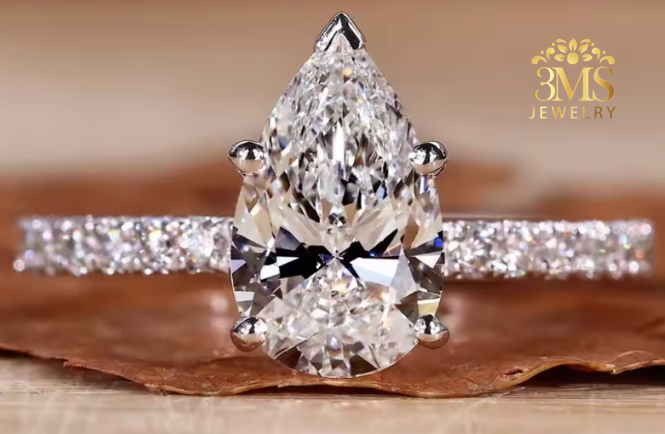 "Lab diamond pear-cut in pave design engagement ring set in 14K white gold—front close-up view."