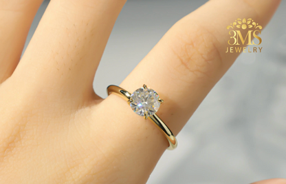 "Lab-grown round brilliant-cut diamond in a solitaire design set in 14K white gold—on wearing zoom view."