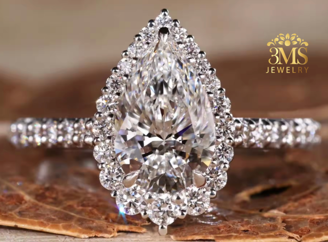 "Lab diamond pear-cut in halo engagement ring set in 14K white gold—front close-up view."