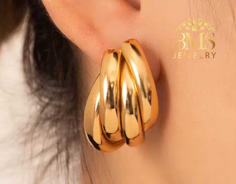 "18K gold drop earring in titanium steel with gold vermeil—era-wearing view" 