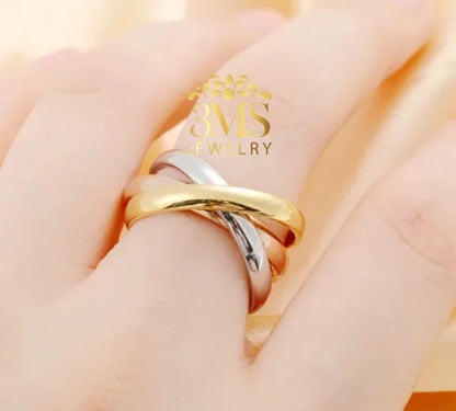 Close-up of hand wearing a stylish gold and silver intertwined love ring by 3MS Jewelry