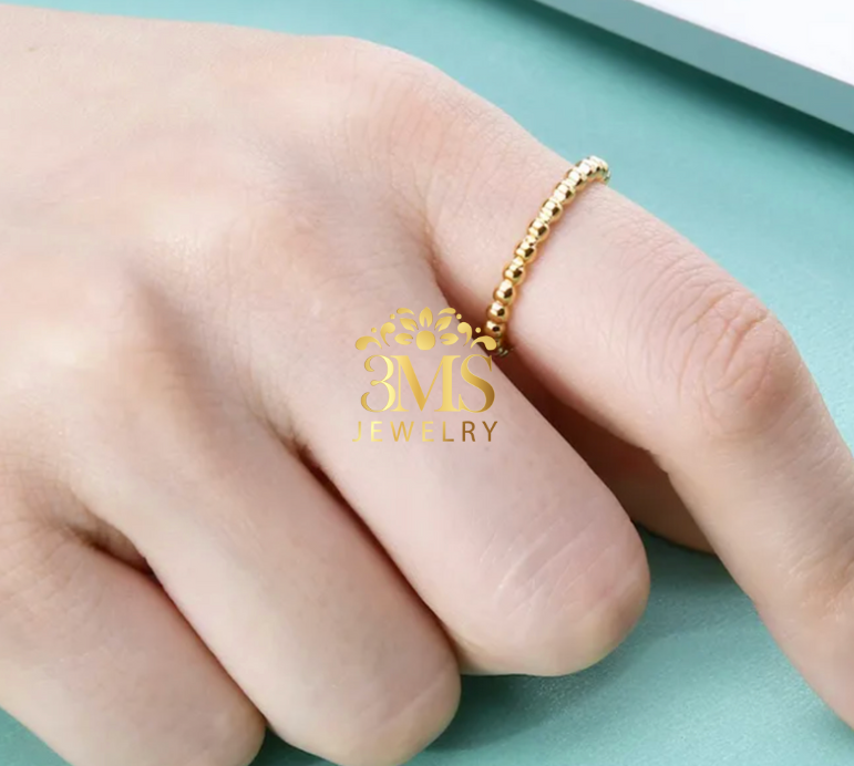 "18K gold beaded ring in titanium steel with gold vermeil—on a finger details"