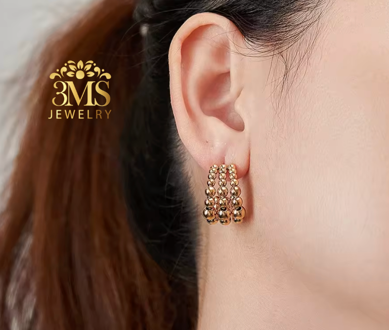 "18K gold hoop bead earrings in titanium steel with gold vermeil—ear-wearing view"