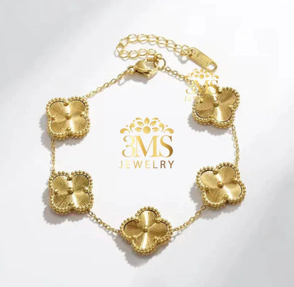 Gold bracelet with five textured flower-shaped charms and adjustable chain clasp on white background
