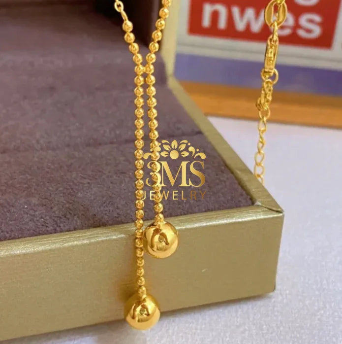 "18K gold two-beaded pendant necklace in titanium steel with gold vermeil—front zoom view"