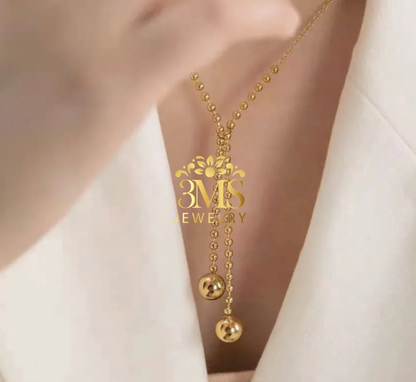 "18K gold two-beaded pendant necklace in titanium steel with gold vermeil—neck-wearing view"