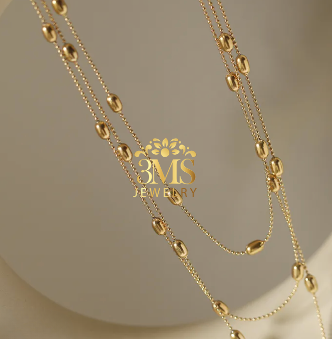 "18K gold three-layered beads necklace in titanium steel with gold vermeil—side view"