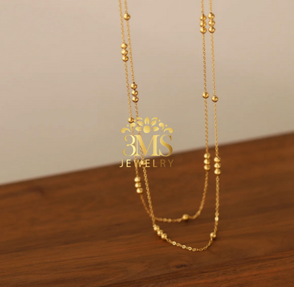 "18K gold 2-layer bead necklace in titanium steel with gold vermeil—front length view"