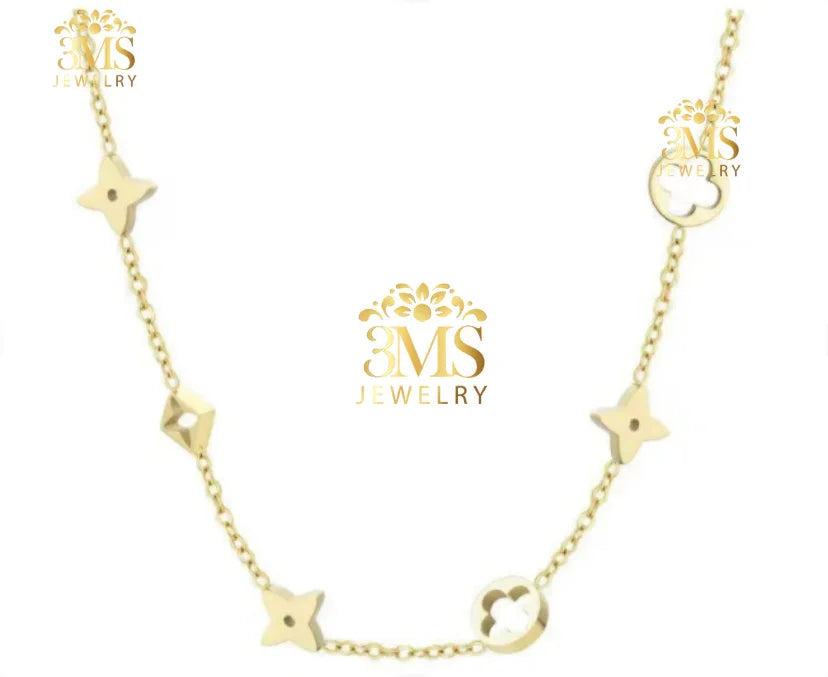 Delicate gold necklace with floral and geometric charms on a fine chain from 3MS Jewelry
