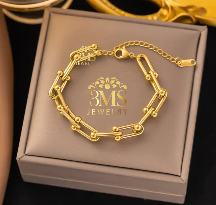Gold link bracelet with small gold bead accents on adjustable chain displayed on 3MS Jewelry box