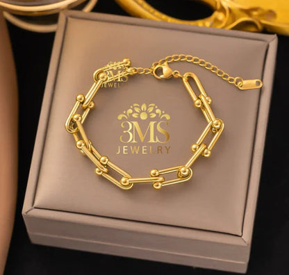 Gold link bracelet with small gold bead accents on adjustable chain displayed on 3MS Jewelry box