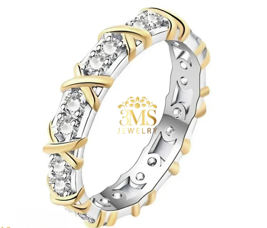 Elegant two-tone gold and silver eternity ring with round cut diamonds and crisscross design