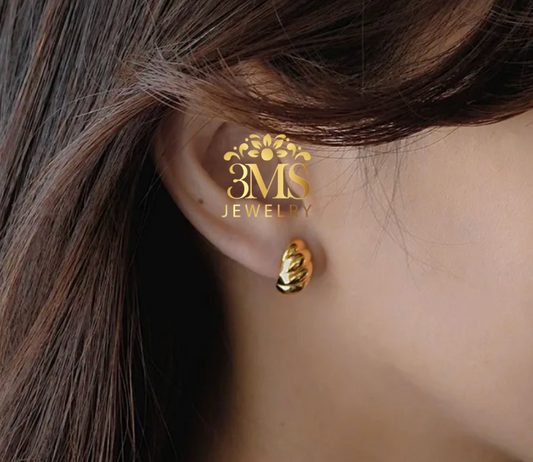 "18K gold stud shell earrings in titanium steel with gold vermeil—on-ear-wearing view"