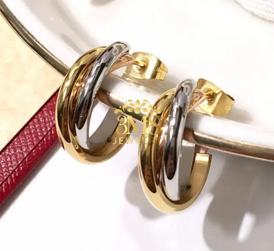 Gold and silver twisted hoop earrings displayed on a white dish with 3MS Jewelry logo