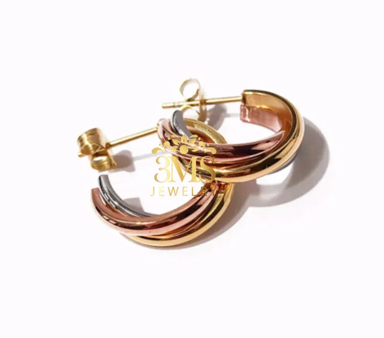Tri-color hoop earrings with gold, rose gold, and silver tones on white background