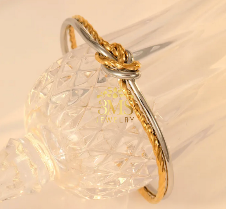 "18K gold knot open bangle bracelet in titanium steel with white gold and yellow gold vermeil—side details"