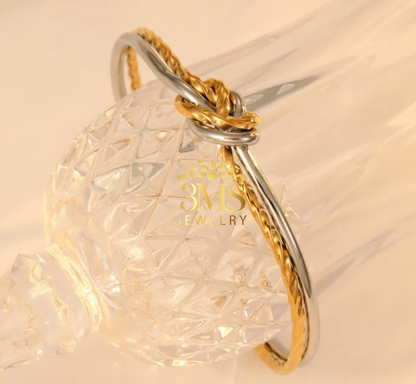 "18K gold knot open bangle bracelet in titanium steel with white gold and yellow gold vermeil—side details"